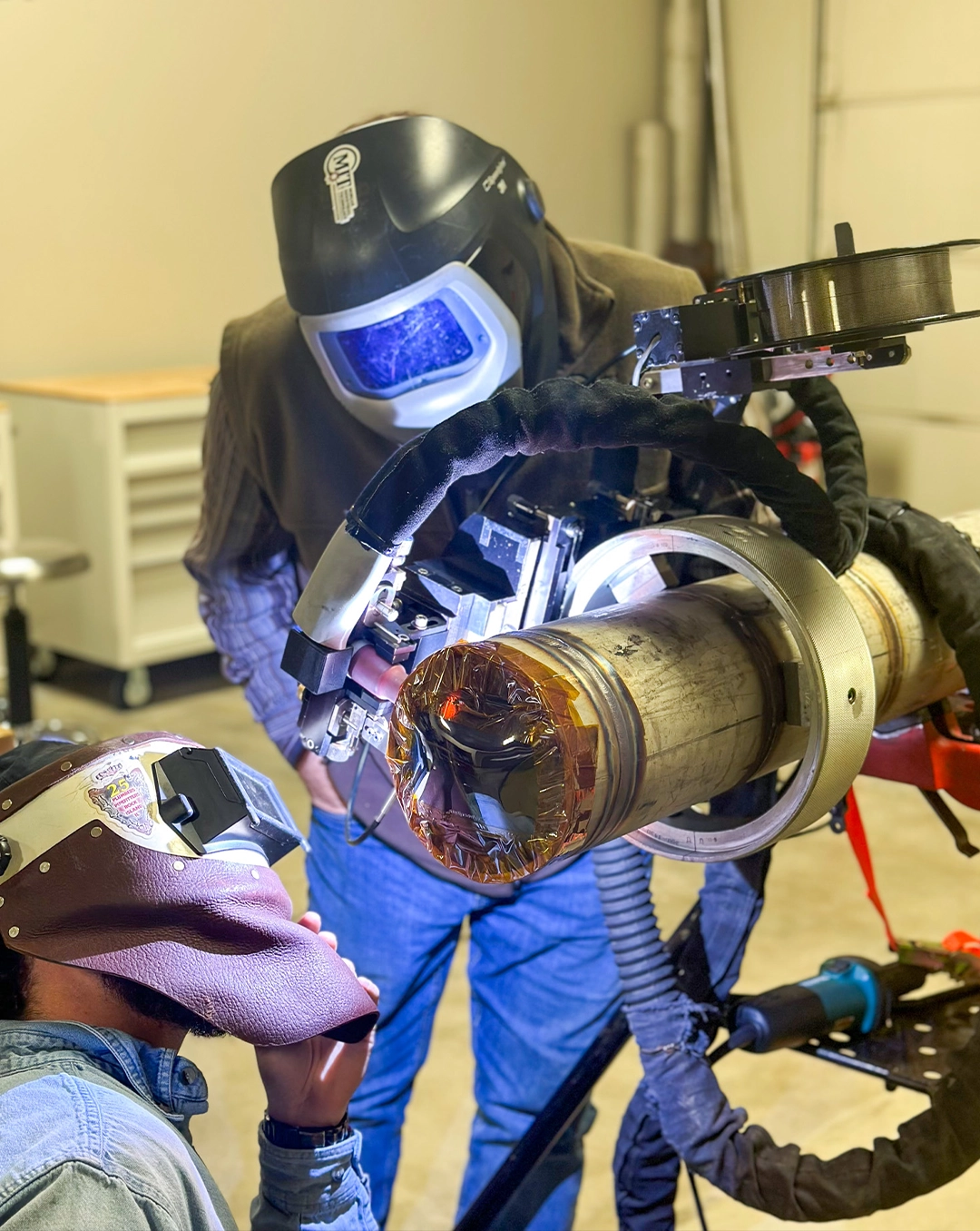 Welders examining the Liburdi Diametrics F-Head